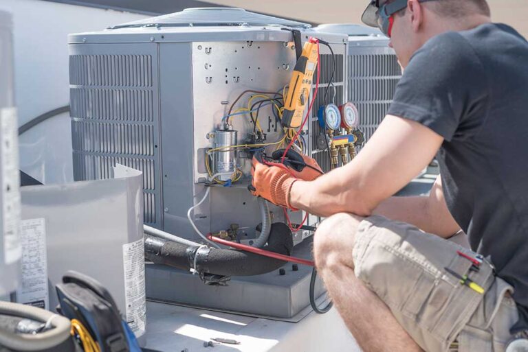 A homeowner and technician reviewing HVAC installation plans beside an outdoor heat pump unit.